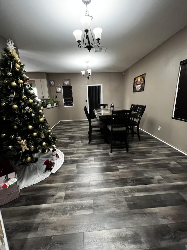 dining room featuring dark wood-type flooring and a notable chandelier