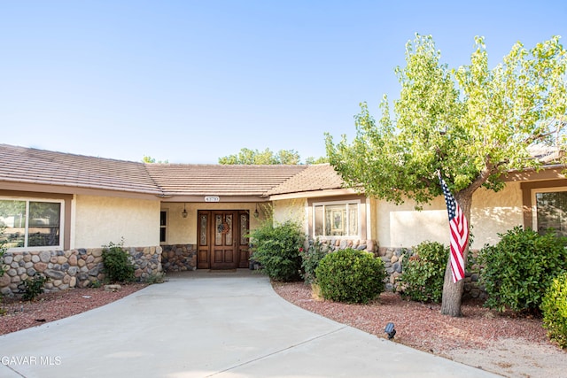 43710 Shiloh Ln, Lancaster, CA 93535 - entrance to property featuring stone siding, stucco siding, and a tile roof
