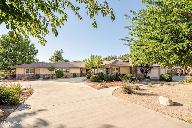 43710 Shiloh Ln, Lancaster, CA 93535 - ranch-style home featuring stone siding, concrete driveway, stucco siding, and an attached garage