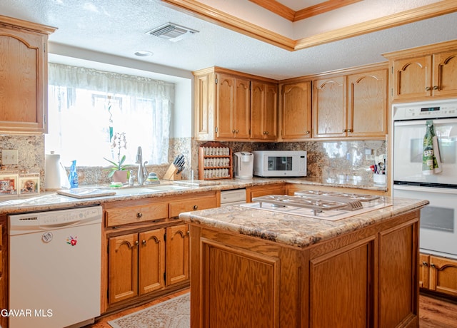 43710 Shiloh Ln, Lancaster, CA 93535 - kitchen with white appliances, light countertops, crown molding, tasteful backsplash, and light wood-style flooring
