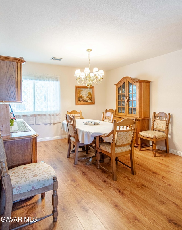 43710 Shiloh Ln, Lancaster, CA 93535 - dining area with light wood-style floors and a chandelier