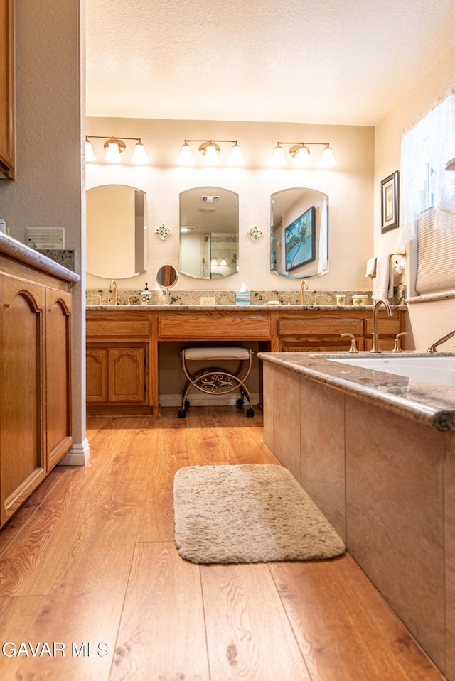 43710 Shiloh Ln, Lancaster, CA 93535 - full bathroom featuring wood finished floors and double vanity
