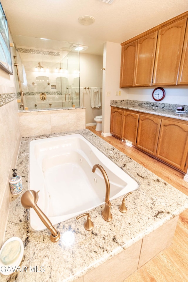 43710 Shiloh Ln, Lancaster, CA 93535 - full bathroom with a stall shower, a tub with jets, wood finished floors, and vanity