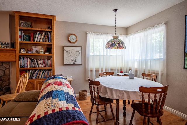 43710 Shiloh Ln, Lancaster, CA 93535 - dining room featuring a textured wall, wood finished floors, and a textured ceiling