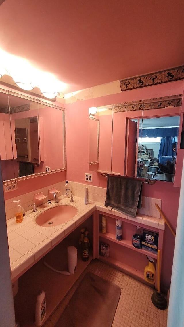 bathroom with tile patterned flooring and sink