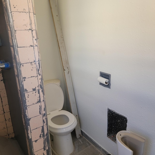 bathroom featuring tile patterned floors and toilet