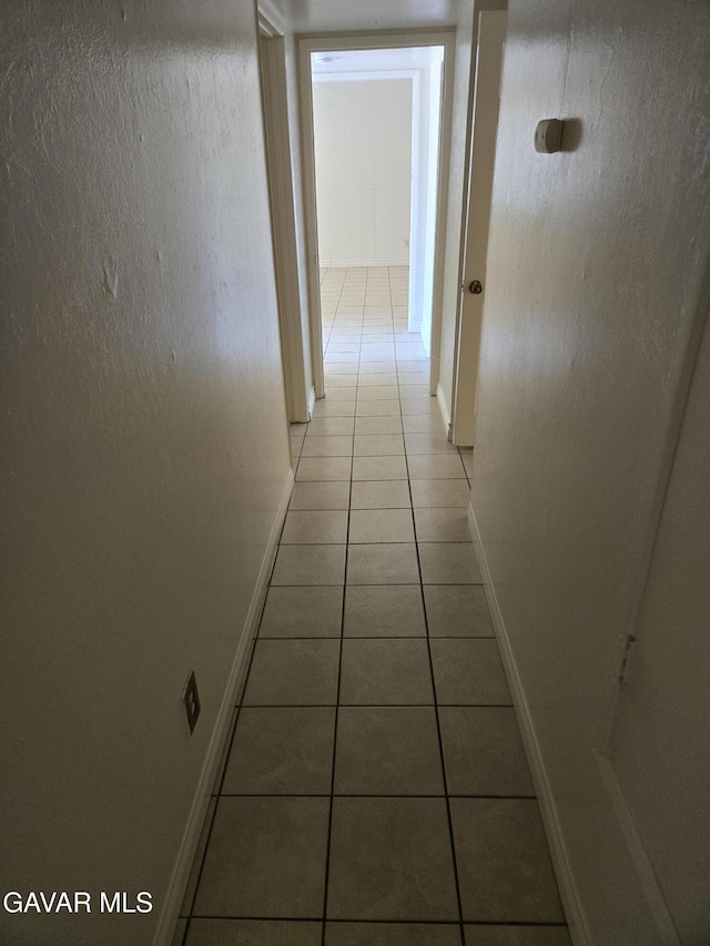 44960 E 3rd St, Lancaster, CA 93535 - corridor with light tile patterned floors and baseboards