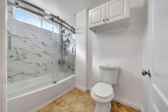 bathroom with shower / bath combination with glass door, tile patterned floors, and toilet