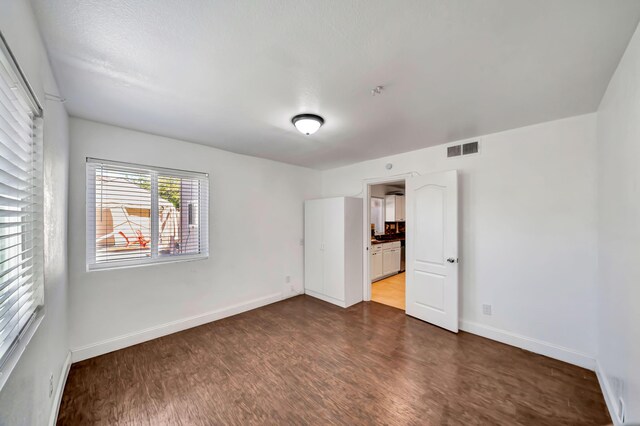 spare room with wood-type flooring