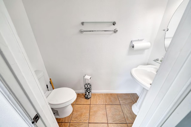 bathroom featuring tile patterned flooring, toilet, and sink