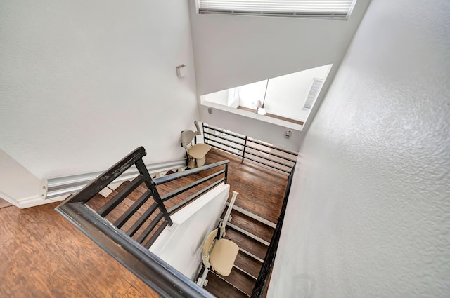 stairs featuring hardwood / wood-style floors