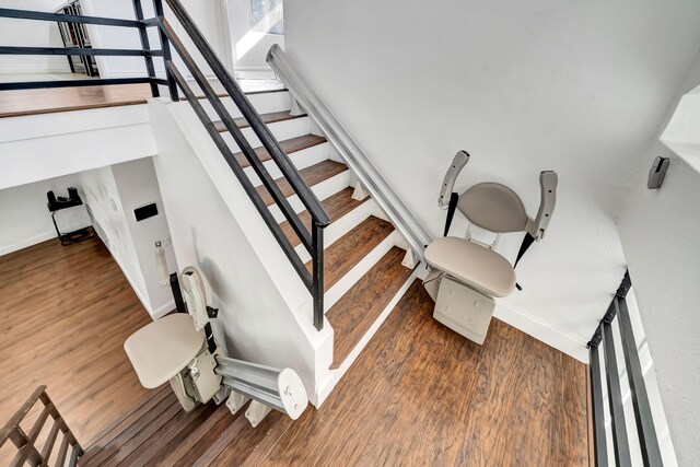 staircase with wood-type flooring