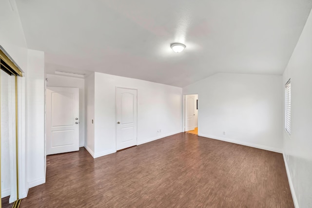 interior space featuring dark hardwood / wood-style flooring and lofted ceiling