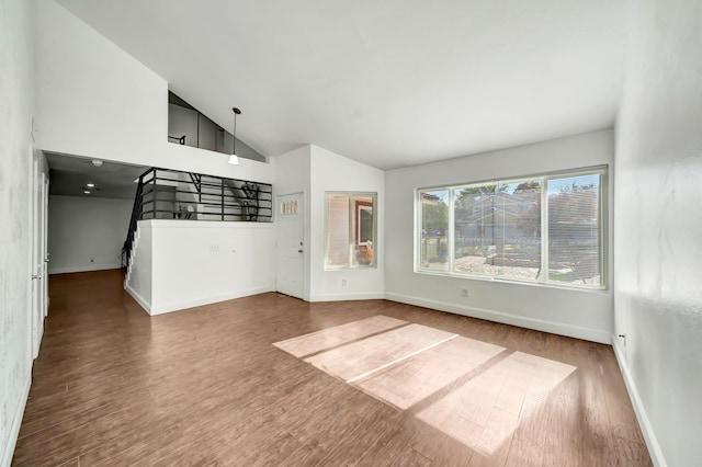 unfurnished living room featuring hardwood / wood-style flooring and high vaulted ceiling