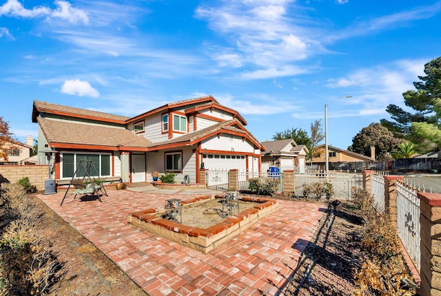 back of property featuring a garage and a patio area