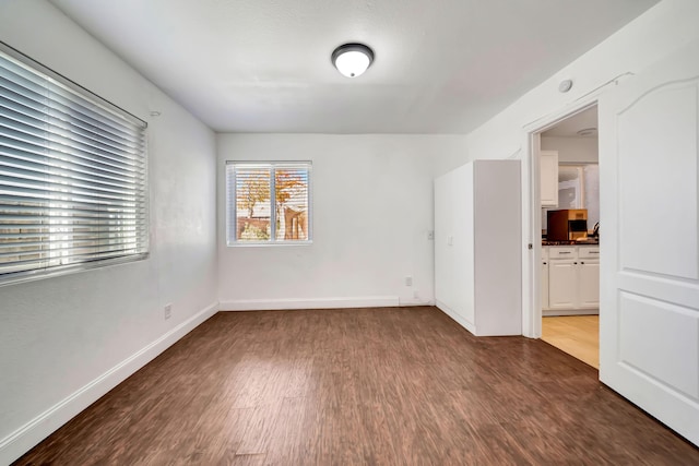 empty room with dark hardwood / wood-style floors