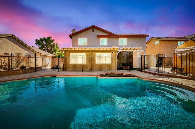 pool at dusk with a pergola