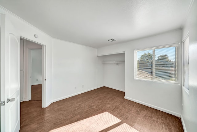 unfurnished bedroom featuring hardwood / wood-style flooring and a closet