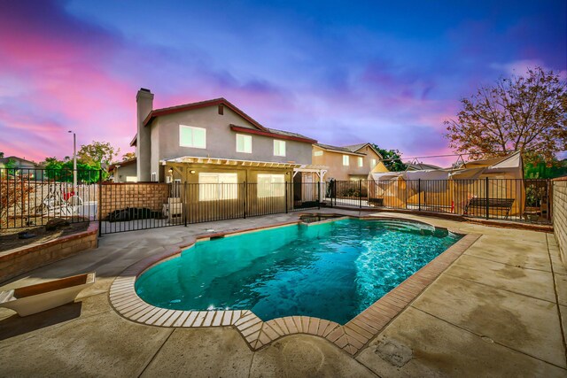 pool at dusk with a patio