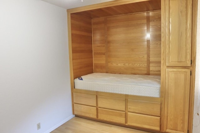 bedroom with a closet and light hardwood / wood-style floors