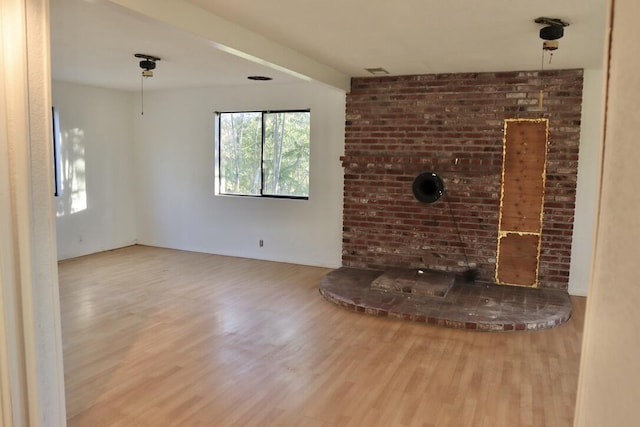 unfurnished living room with hardwood / wood-style floors