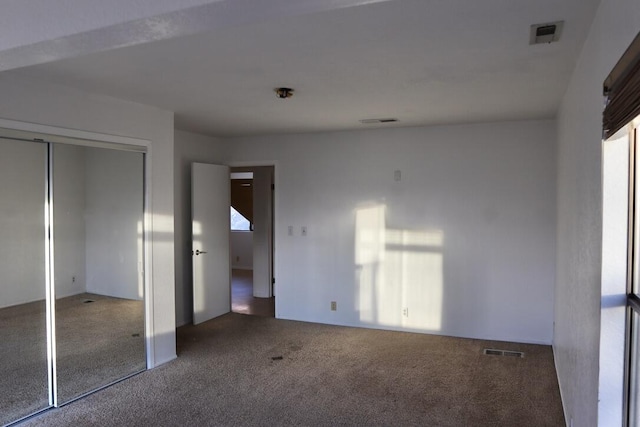 unfurnished bedroom featuring carpet flooring and a closet