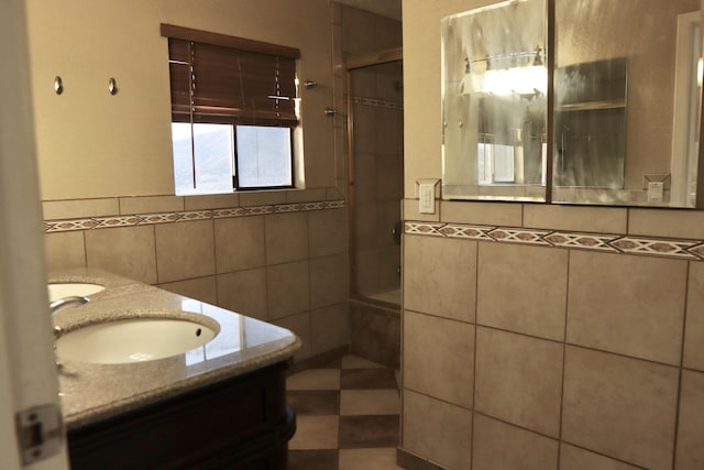 bathroom featuring vanity, tile walls, and tiled shower