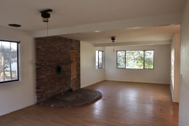 unfurnished living room featuring wood-type flooring