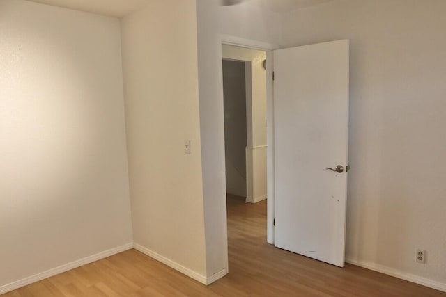 empty room with light hardwood / wood-style flooring