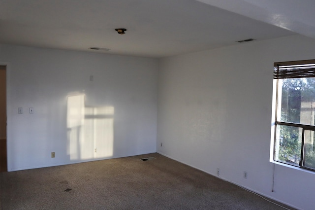 unfurnished room featuring carpet flooring