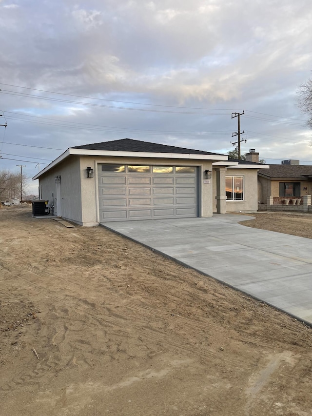 view of front facade featuring cooling unit and a garage