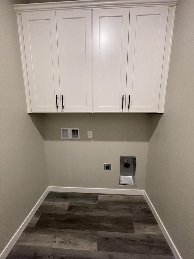 washroom featuring dark wood-type flooring, cabinets, washer hookup, and electric dryer hookup