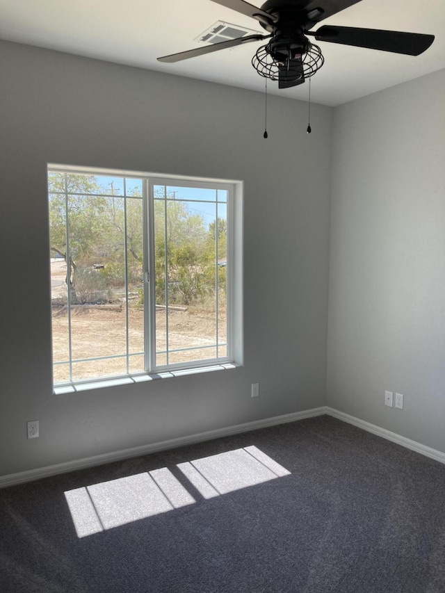 carpeted spare room with ceiling fan