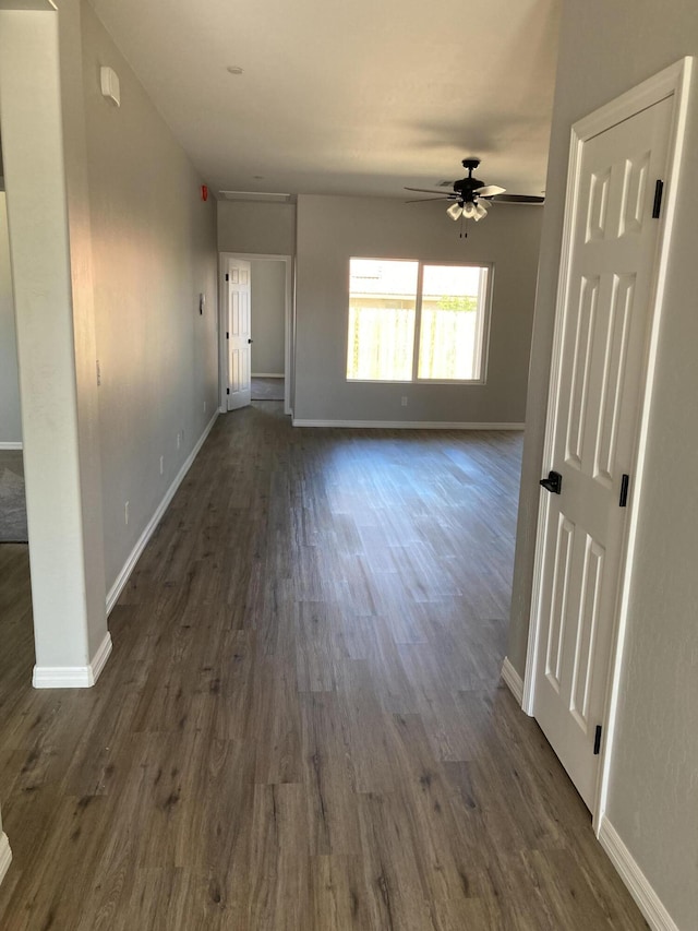 interior space with ceiling fan and dark hardwood / wood-style floors