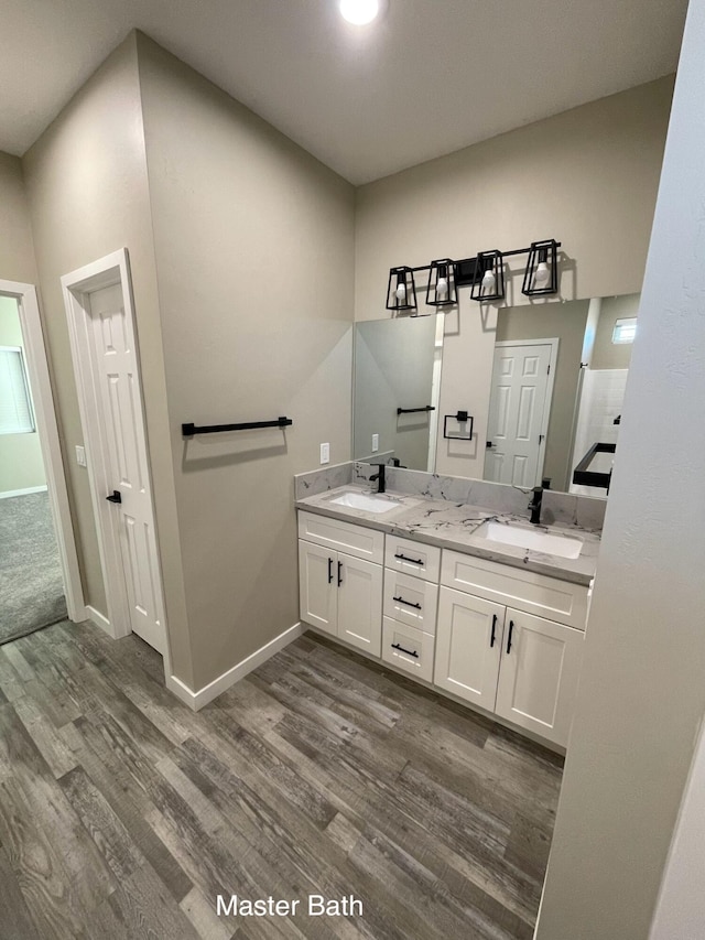 bathroom featuring hardwood / wood-style flooring and vanity