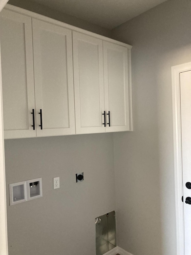 laundry area with cabinets, hookup for a washing machine, and hookup for an electric dryer