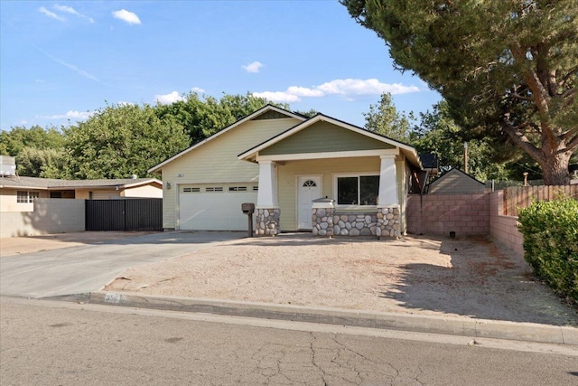 350 E Nugent St, Lancaster, CA 93535 - view of front of home featuring driveway, an attached garage, and a gate