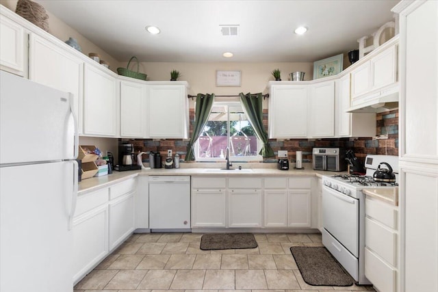 350 E Nugent St, Lancaster, CA 93535 - kitchen featuring white appliances, under cabinet range hood, a sink, tasteful backsplash, and recessed lighting
