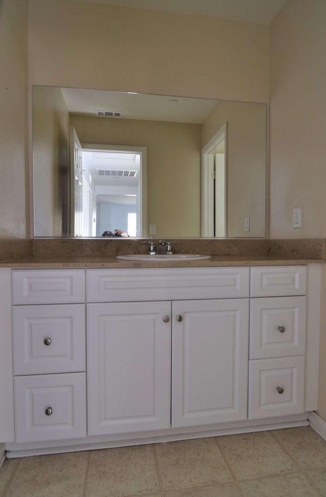 bathroom with vanity and tile patterned flooring