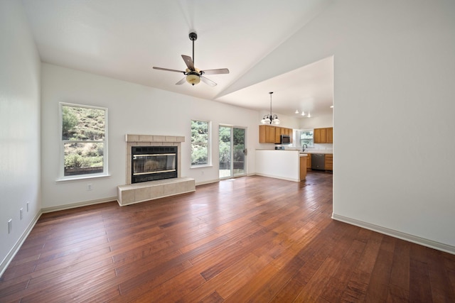 24481 Jacaranda Dr, Tehachapi, CA 93561 - unfurnished living room with a ceiling fan, a fireplace, dark wood finished floors, a sink, and baseboards