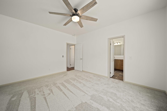 24481 Jacaranda Dr, Tehachapi, CA 93561 - unfurnished bedroom featuring carpet flooring, ensuite bathroom, baseboards, and a ceiling fan
