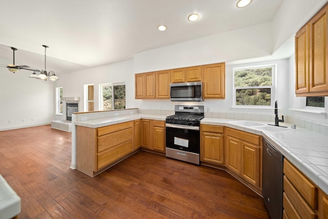 24481 Jacaranda Dr, Tehachapi, CA 93561 - kitchen with appliances with stainless steel finishes, a sink, a peninsula, tile counters, and recessed lighting