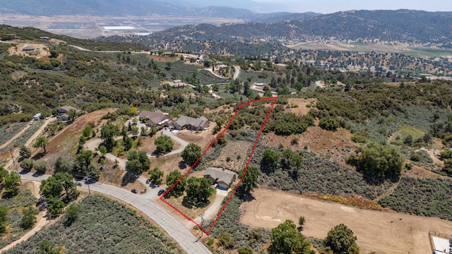 24481 Jacaranda Dr, Tehachapi, CA 93561 - aerial view of property's location with a mountain backdrop and property parcel outlined