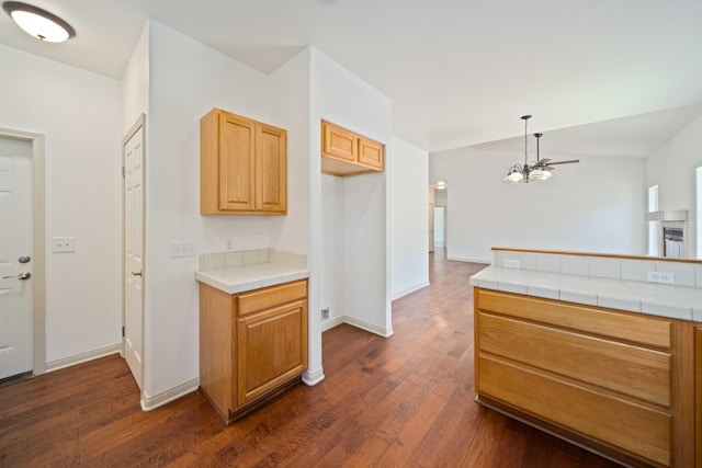 24481 Jacaranda Dr, Tehachapi, CA 93561 - kitchen with a chandelier, dark wood-style flooring, tile countertops, and baseboards