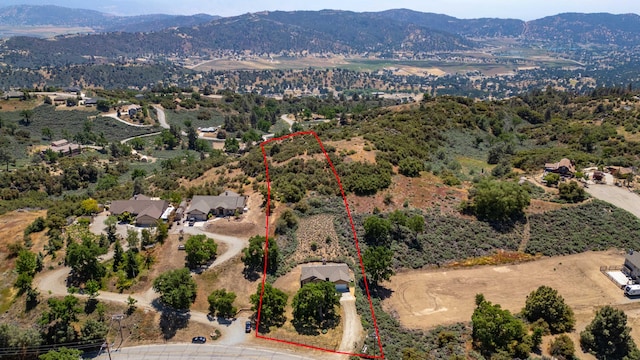24481 Jacaranda Dr, Tehachapi, CA 93561 - aerial view of property and surrounding area featuring mountains and property parcel outlined
