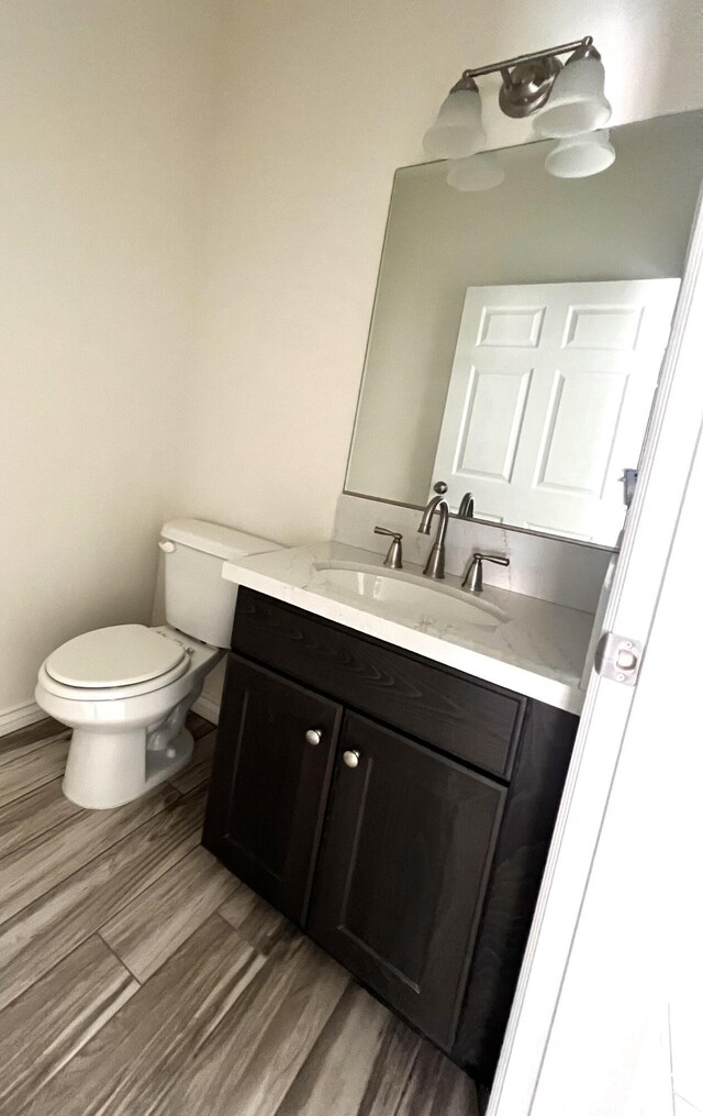 bathroom with a shower with door and hardwood / wood-style floors