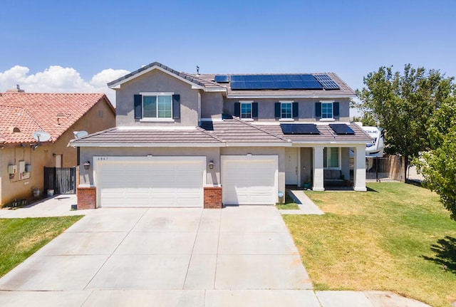 view of front of property featuring solar panels, a garage, and a front lawn