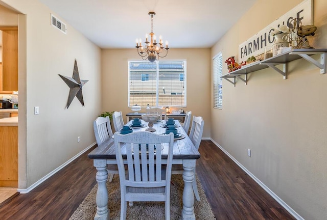 dining area featuring dark hardwood / wood-style flooring and a notable chandelier