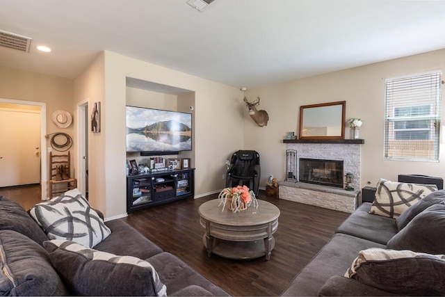 living room with dark hardwood / wood-style floors and a fireplace