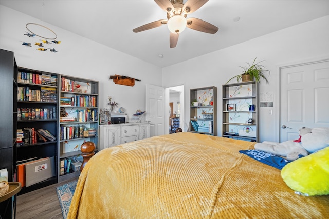 bedroom with dark hardwood / wood-style floors and ceiling fan